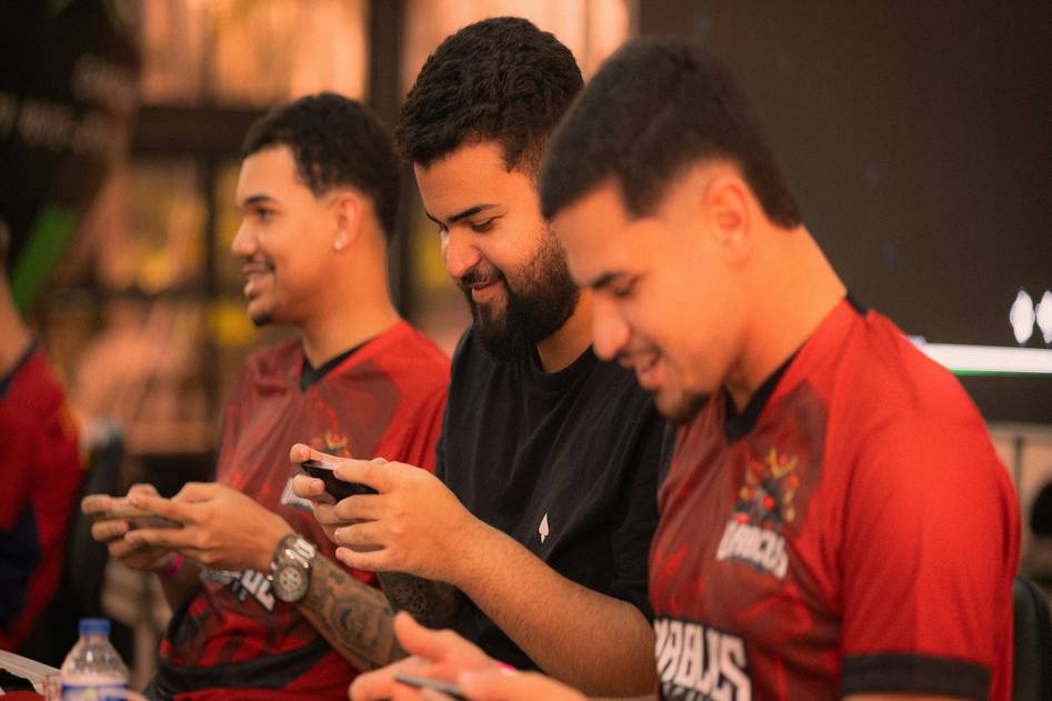 Mobile gamers competing in a strategy battle on smartphones